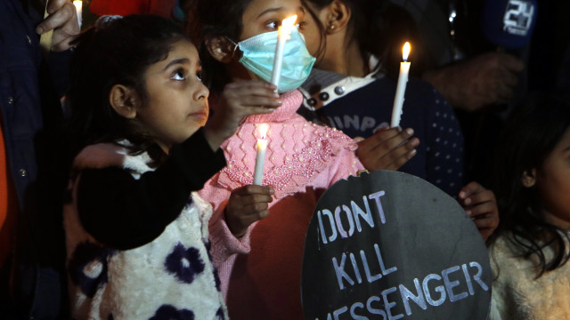 Pakistani journalists and their families hold candles to mark International Day to End Impunity for Crimes Against Journalists, in Islamabad, Pakistan, 19 November 2020